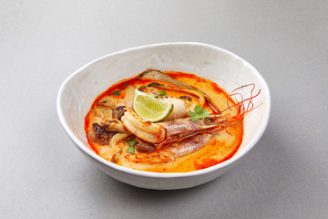 tom yam, shrimp and fish in tomato sauce with herbs and lime , seafood soup