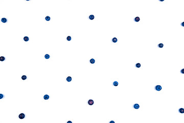 White background with blueberries laid out in a pattern.