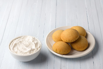 Homemade gluten free cottage cheese rice cookies and bowl rice flour on light background, selective focus. tasty healthy food