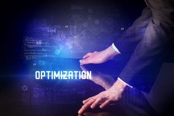 Hand touching digital table with OPTIMIZATION inscription, new age security concept