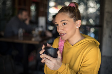 Thinking over her day with a fresh cup of coffee.