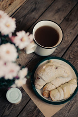 Homemade oatmeal bakery products with a cup of tea on old wooden background