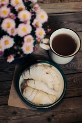Homemade oatmeal bakery products with a cup of tea on old wooden background