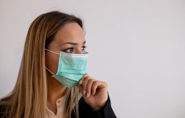 The young business woman in medical mask