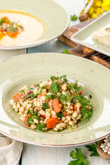 Several dishes of pumpkin soup, salad and sandwich