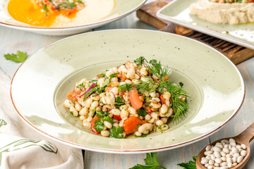 Several dishes of pumpkin soup, salad and sandwich