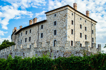 Fototapeta na wymiar Old building made of stone against the blue sky.