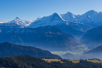 snowcapped Eiger, Moench and Jungfrau mountains with blue sky