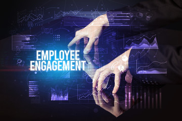 Businessman touching huge screen with EMPLOYEE ENGAGEMENT inscription, cyber business concept