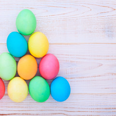 Easter fun background. Eggs on wooden texture