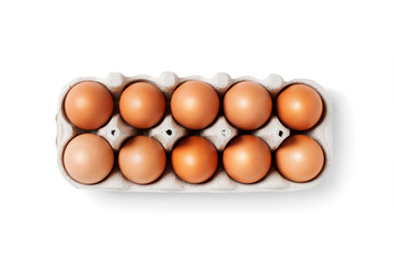 Isolated box with ten brown eggs on white background.
