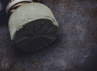 Protective gas mask with a filter on a gray dirty background, doomsday, virus