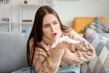 Coughing young woman at home