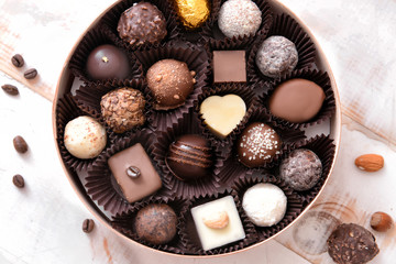 Box with delicious candies on table