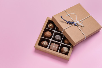 Box with delicious candies on color background