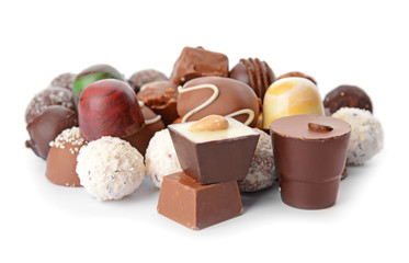 Assortment of delicious candies on white background