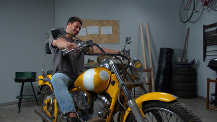 Fototapeta na wymiar Men sits on motorcycle and starts the engine 