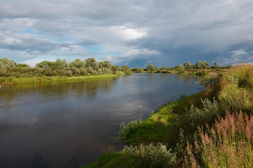 Fototapeta na wymiar cloudy clouds over the river in summer