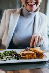 close up of woman eating in restaurant