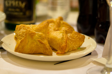 dough envelopes baked puff pastries on a plate