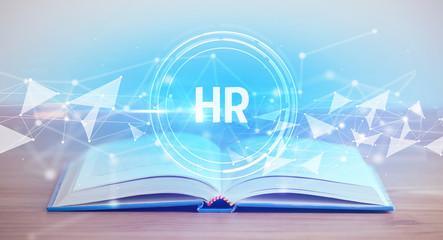 Open book with HR abbreviation, modern technology concept