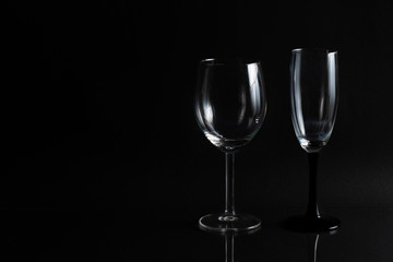 Empty glass for wine on a black background with space for text