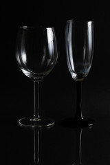 Two empty glasses for wine on a black background