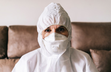 Portrait of protected woman with safety suit, glasses and mask before a pandemic or virus