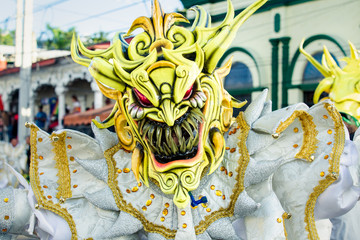 closeup human in sparkling demon costume poses for photo at dominican carnival