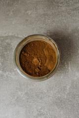 Cocoa powder in a glass jar, top view. Superfood concept