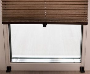 Pleated blinds with small fold 20mm close up on the window. Brown color bottom up top down home...