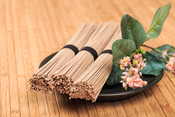 Buckwheat noodles closeup. Raw food ingredient. Dried buckwheat soba noodles. Traditional Japanese food - Image