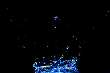 blue splash in the dark room