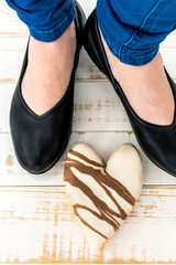 Isolated female brown leather shoes on wood background