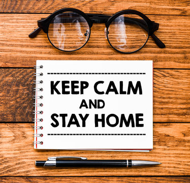 Keep Calm And Stay Home Text On Note With Pen. 