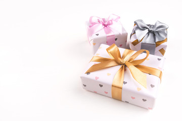 Three gift boxes with bows on a white background. Birthday, christmas, wedding or another holiday concept.