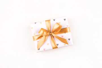 One gift boxe with bow and on a white background. Flat lay composition. Birthday, christmas, wedding or another holiday concept.