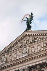 The roof of Lviv theatre of opera and ballet. The central sculpture is Glory. Bas-relief with many figures.