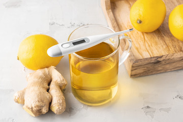 Alternative medicine, natural home remedy for cold and flu. Hot herbal tea with ginger and lemon