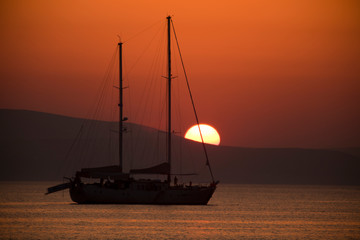 Alyko beach, Naxos / Greece - August 23, 2014: Sunset at Alyko beach in Naxos, Cyclades Islands,...