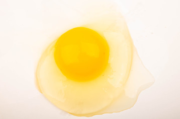 A broken chicken egg without a shell on a white background. Close up.