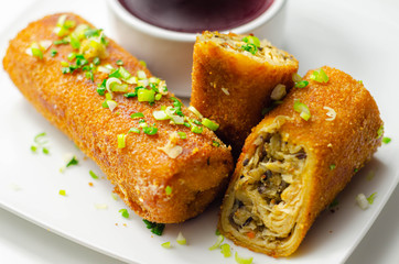 Delicious croquettes with sauerkraut and mushrooms served with hot red borscht