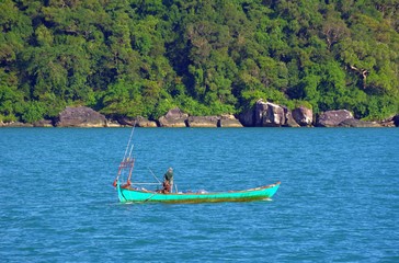 Fototapeta na wymiar Lone fisherman returns home after fishing