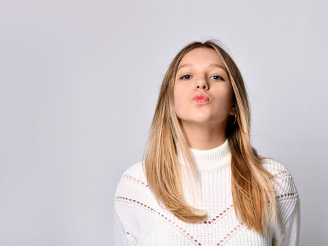 First Kiss, Unwanted Kiss Concept. Closeup Portrait Of Young Woman Face Rying To Kiss You Camera, Isolated Light White Background.