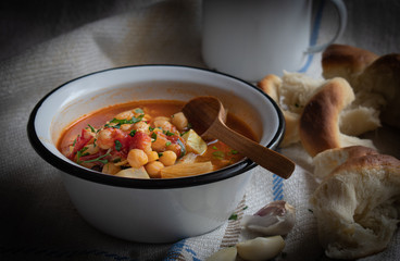 Vegan chickpea and vegetable soup in a rustic setting