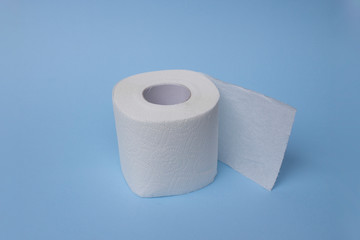 Roll of toilet paper or tissue isolated on blue. Simple toilet paper on blue background. Close-up image of toilet paper studio isolated on background