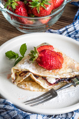 Polish pancakes with jam, cheese and strawberries.