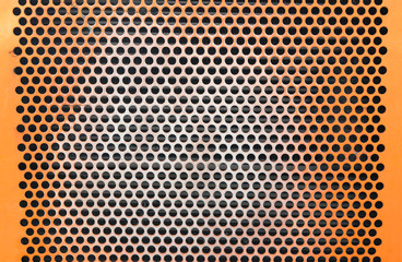 perforated metal grid many holes orange construction texture background