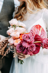  Floristics in the style of fine art in Europe. Light bouquet of peonies and roses. Modern wedding bouquet in the hands of the bride.