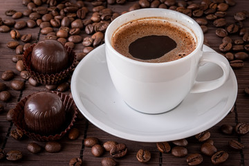 Coffee cup and a scattering of coffee beans